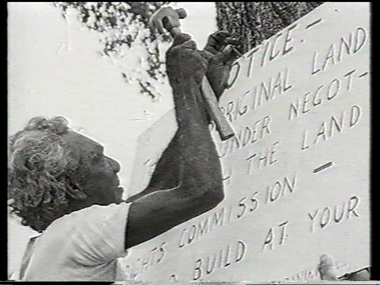 Bobby Secretary nails up a sign to a tree in Ostermann Street Coconut Grove, June 1973